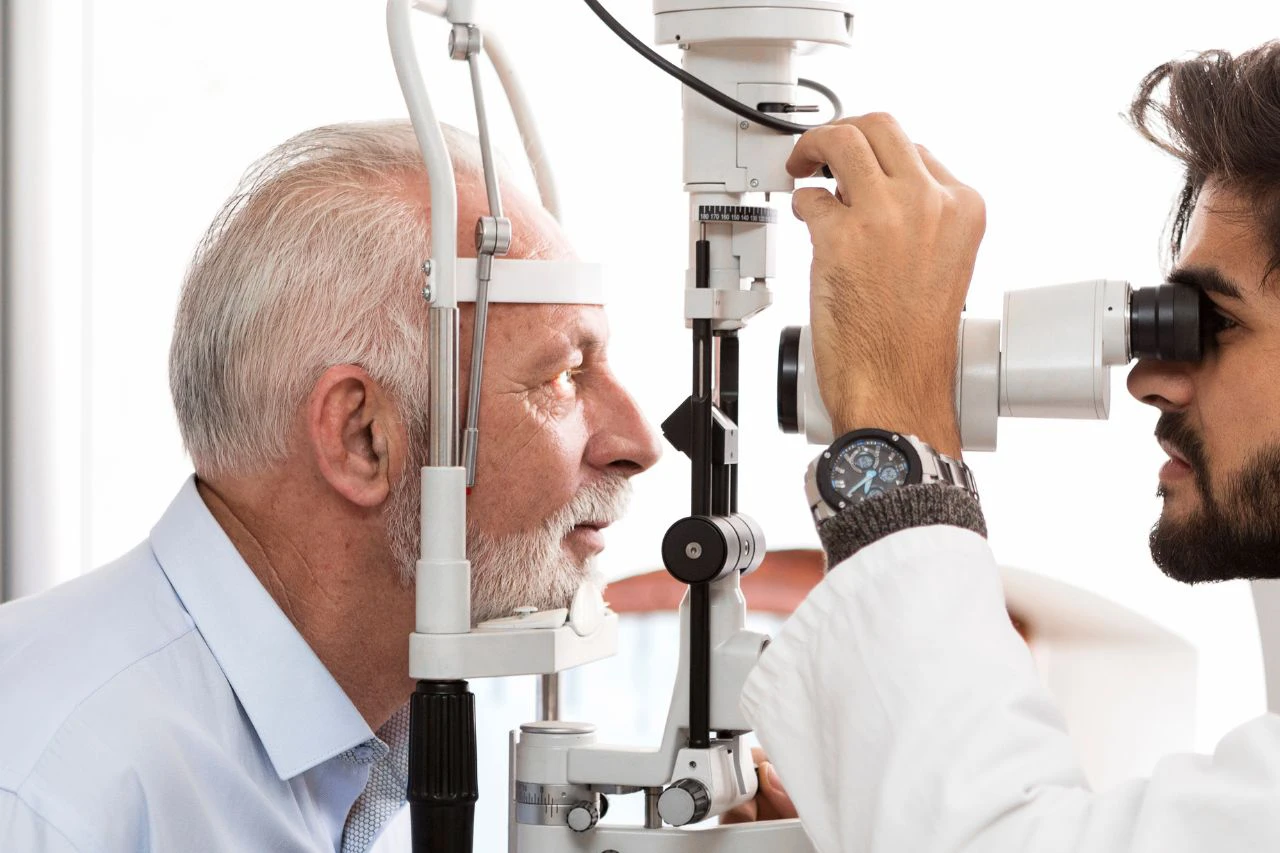 a woman sitting in a chair while a woman combs her hair